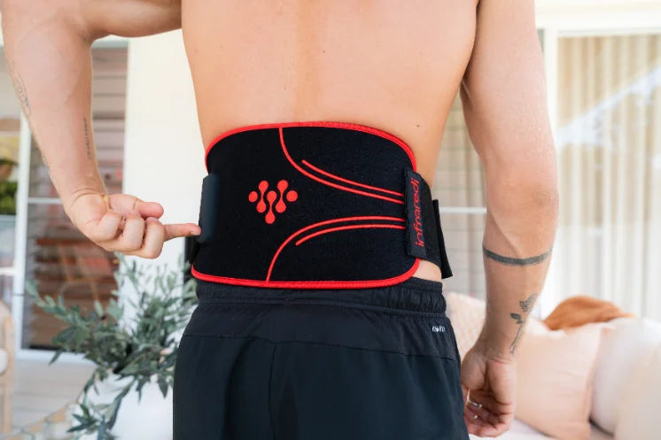 Rear view of a man wearing an Infraredi body wrap across his lower back.