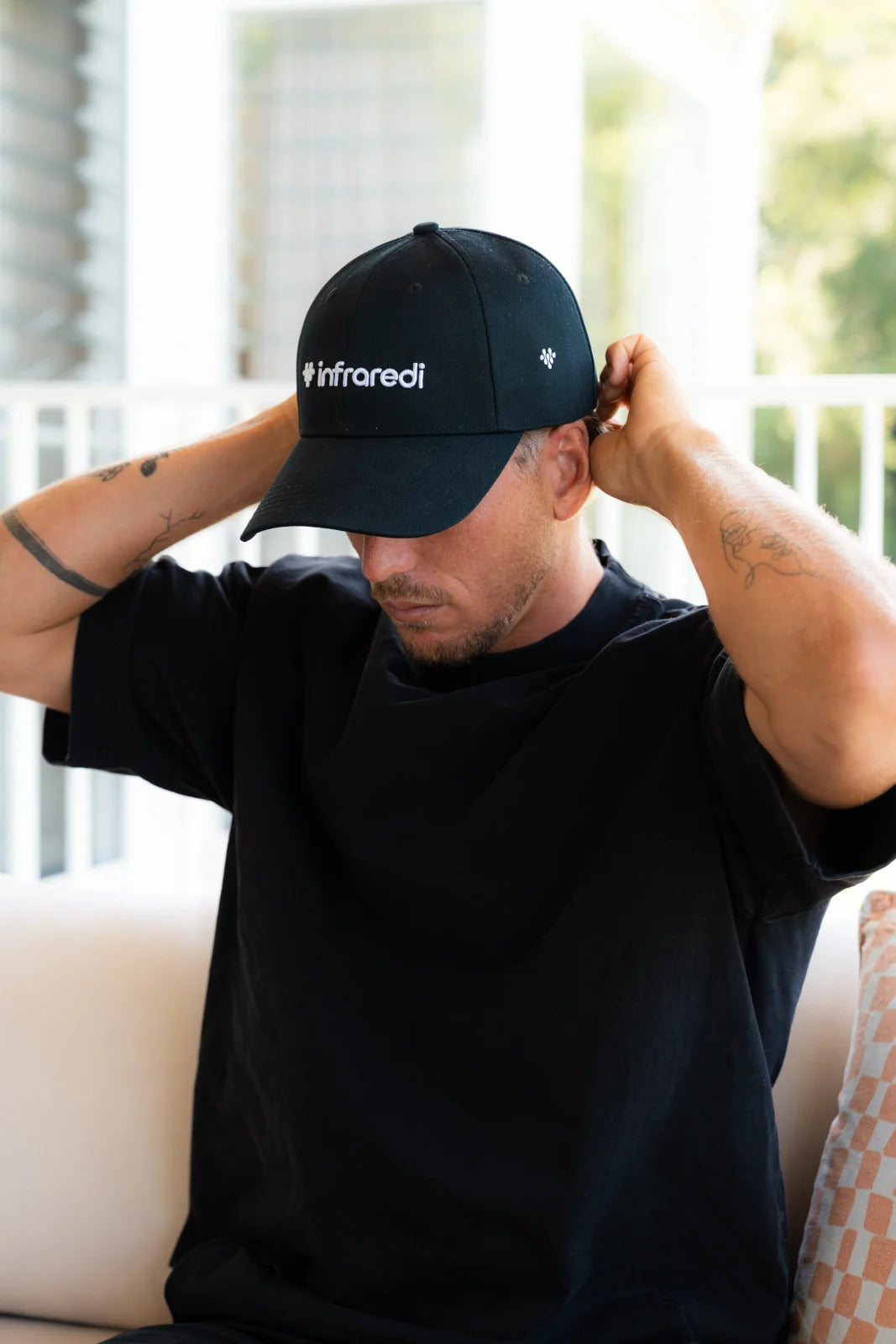 Man putting on the Infraredi Hair Growth Hat
